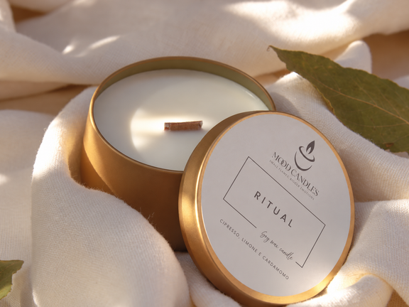 Aurea Ritual con stoppino in legno, contenitore dorato e note di cipresso, limone e cardamomo.